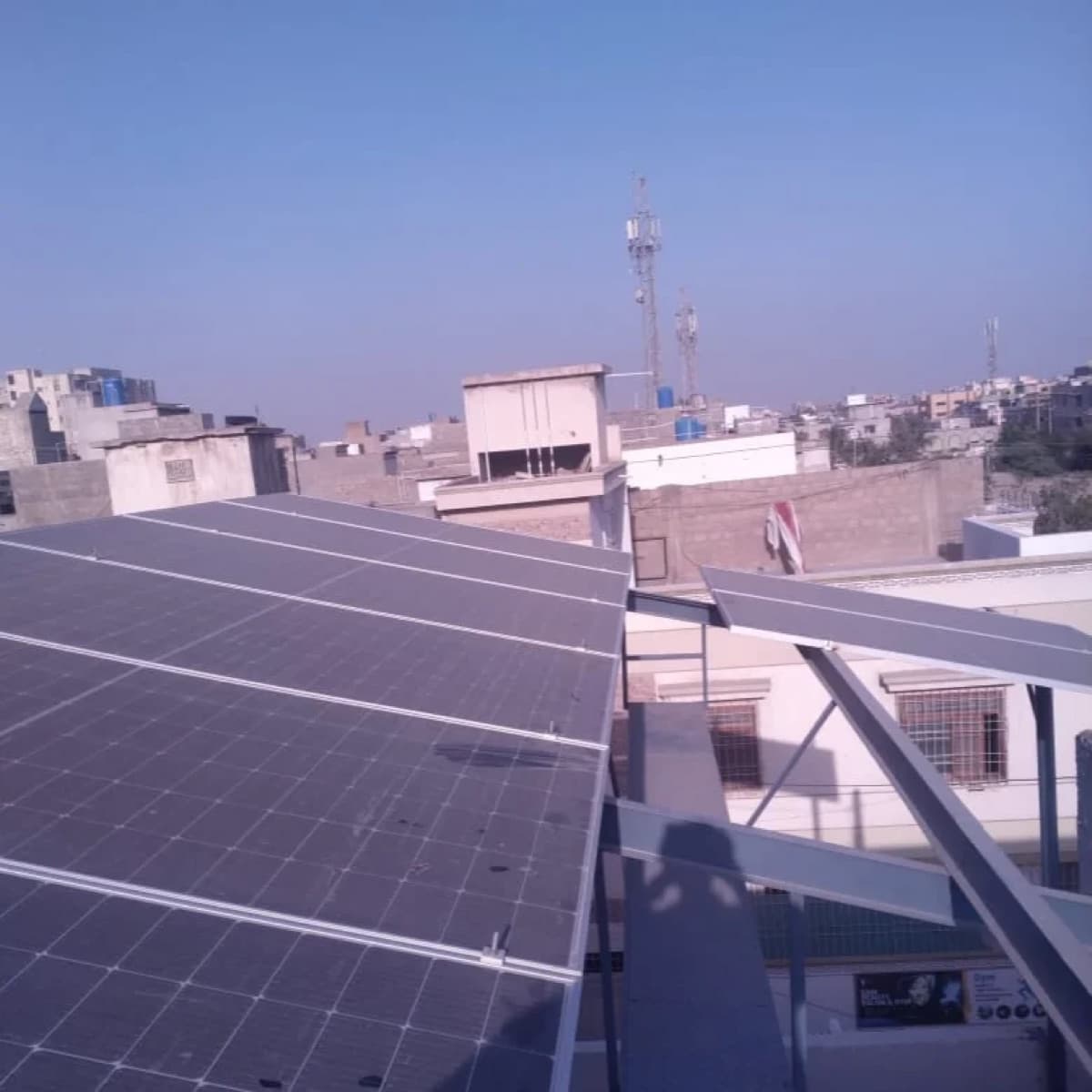 Solar panels installed by MAT Energy on an elevated rooftop structure in Karachi